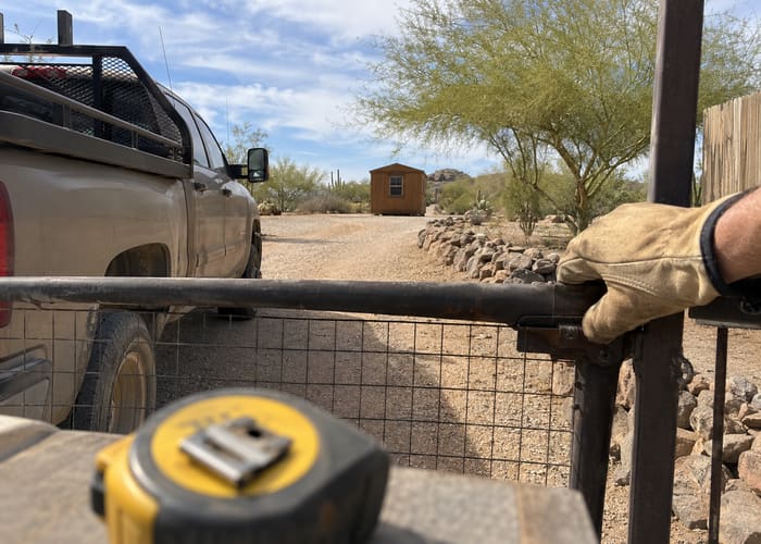 Checking a gate's clearance next to the work truck before scheduling a move